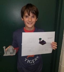 Student holding 3-D house