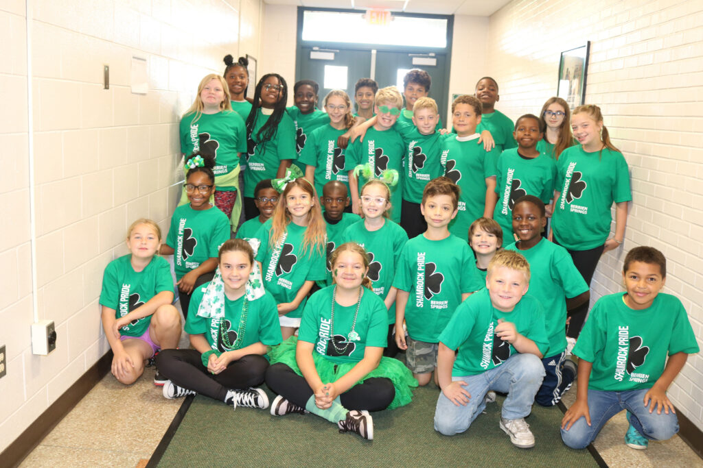 Group of young students with their Shamrock Pride shirts on