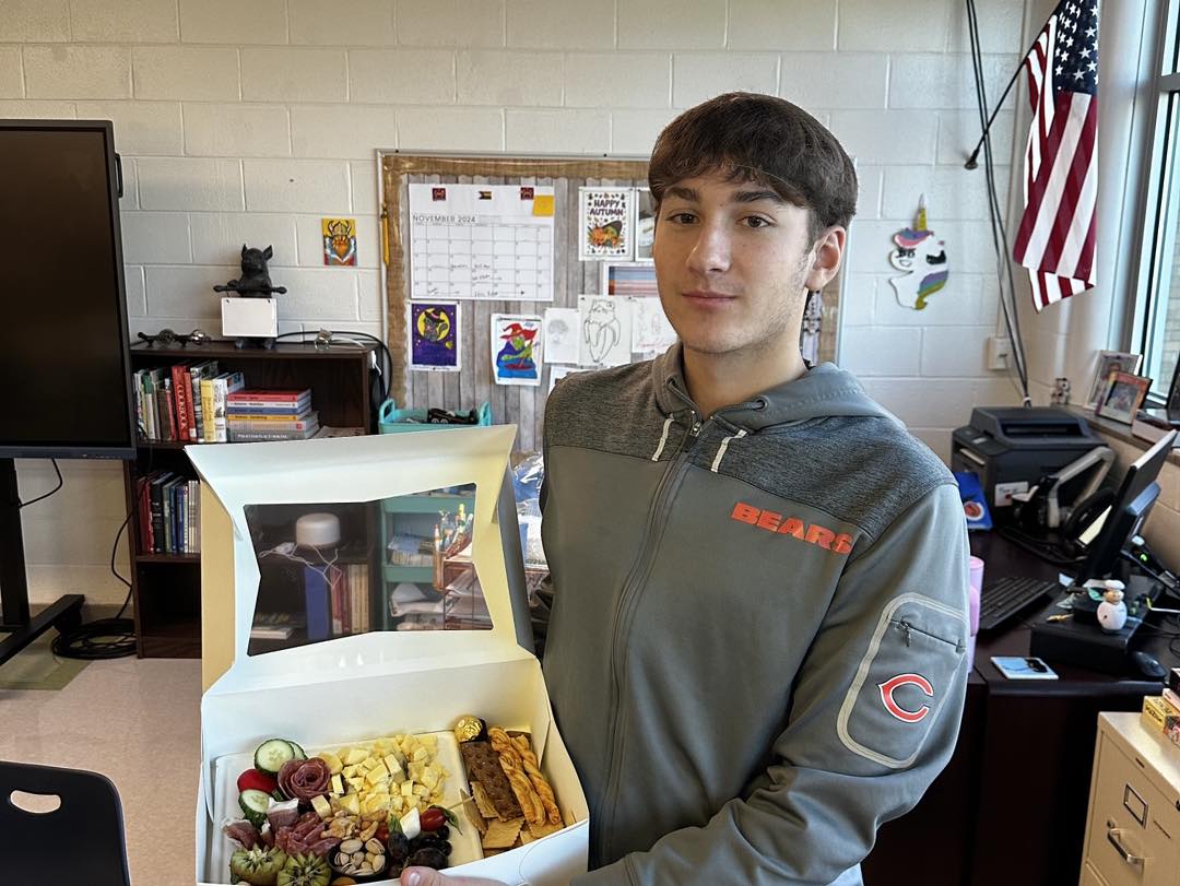 Male student with desserts he made