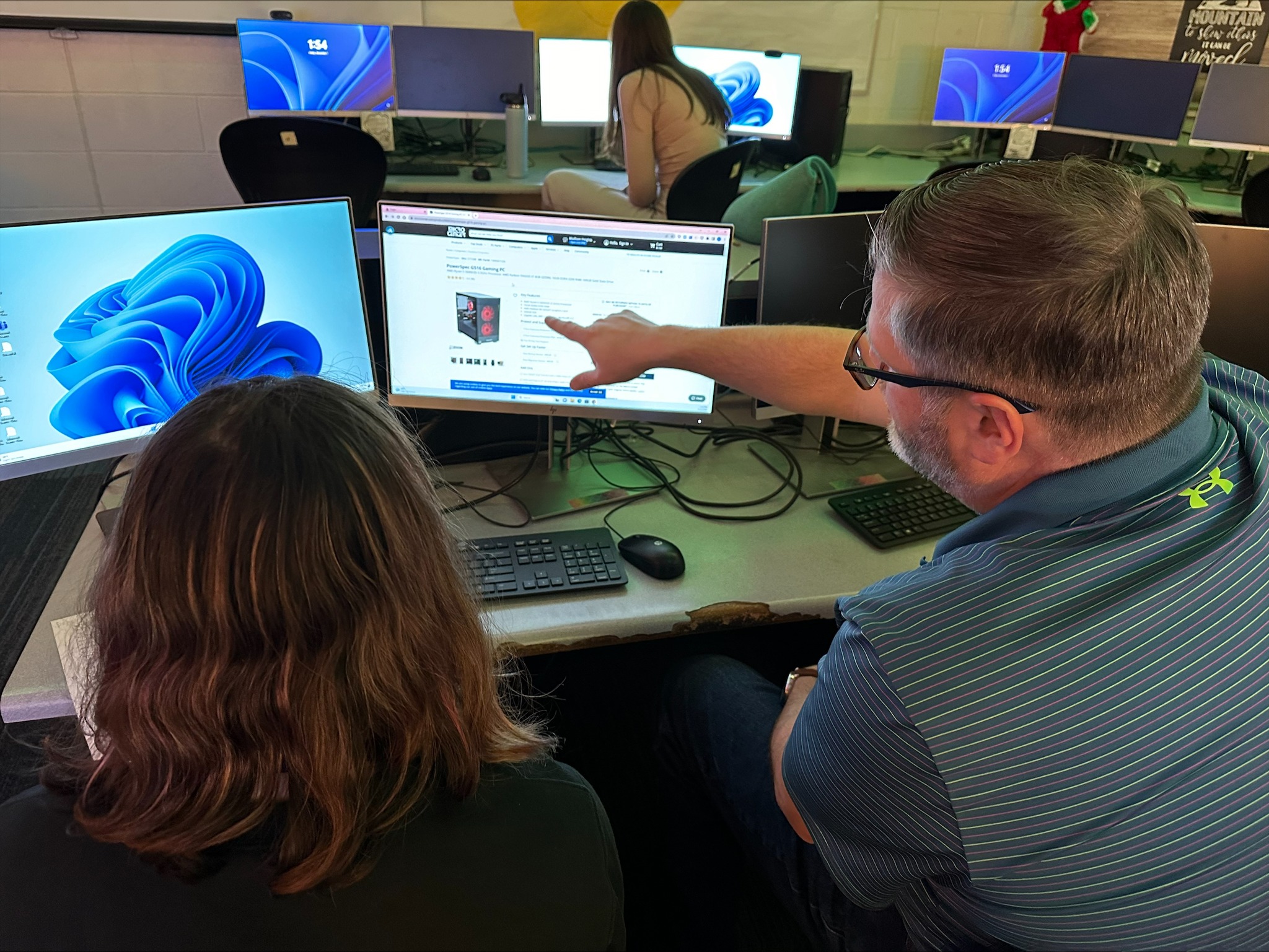 Adult showing student computer programming