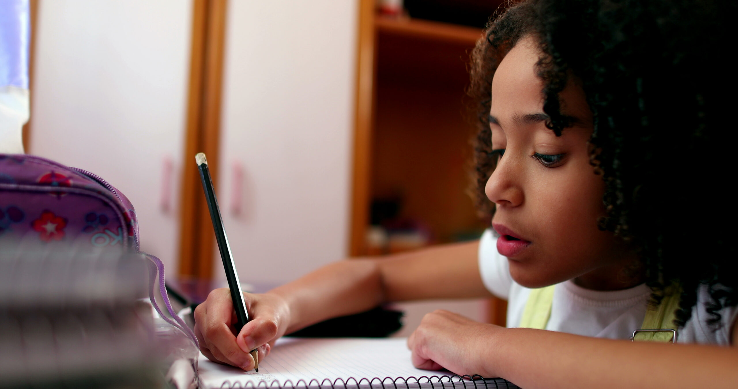 Focused,Little,Girl,Child,Writing,Notes,On,Notepad